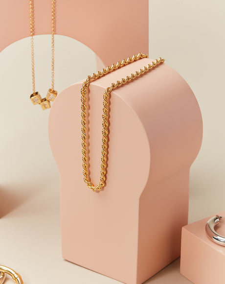 Styled product photography of the Francesca Rope Chain and the Gioci Chain and Dice.