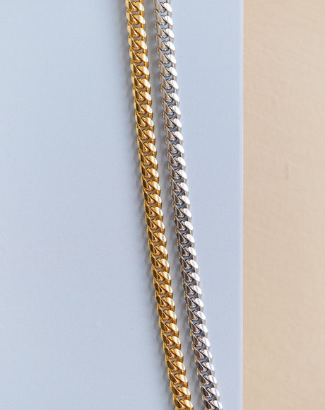 Styled product photography of the Navona Gold and Silver Chains.